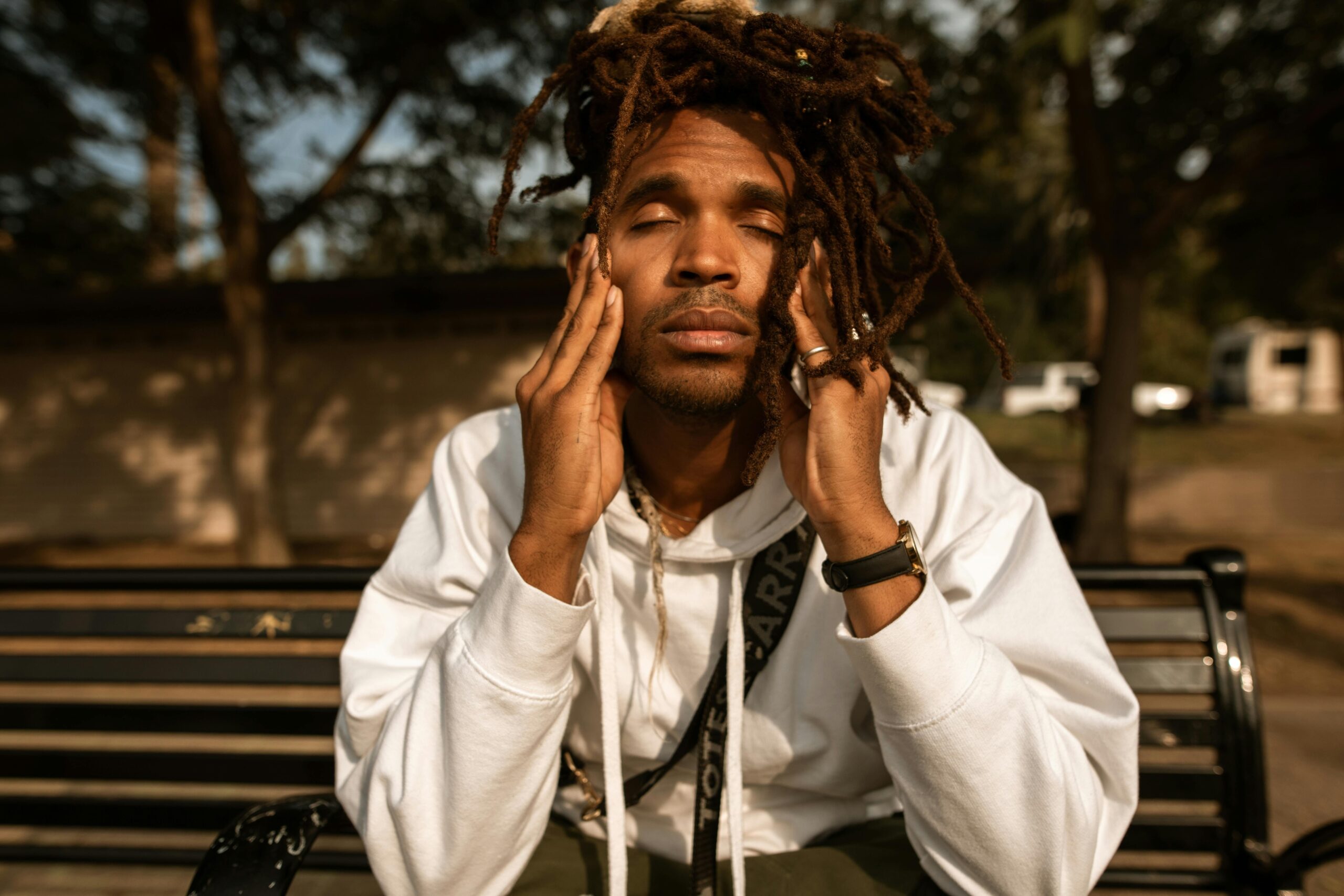 A person practicing mindfulness meditation outside with hands cupped over their nose.